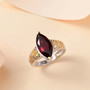 marquise garnet solitaire ring in 18k yellow gold and rhodium over sterling silver shown in a lifestyle photo