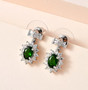 chrome diopside and zircon bow earrings in rhodium over sterling silver shown in a lifestyle photo