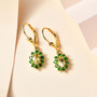 heliodor and chrome diopside halo lever back earrings in 18k yellow gold over sterling silver shown in a lifestyle photo