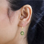 heliodor and chrome diopside halo lever back earrings in 18k yellow gold over sterling silver worn on the ear