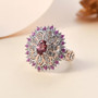 rhodolite garnet pink sapphire and zircon ring in 18k rose gold and rhodium over sterling silver shown in a lifestyle photo