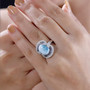 larimar tanzanite and moissanite ring in rhodium over sterling silver worn on a hand
