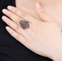 black garnet cluster ring in rhodium over sterling silver worn on a hand