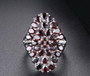 black garnet cluster ring in rhodium over sterling silver shown in a lifestyle photo