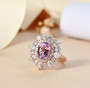 kunzite and moissanite ring in 18k rose gold over sterling silver shown in a lifestyle photo
