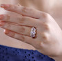 pink spinel and white zircon trilogy halo ring in 18k rose gold over sterling silver worn on a hand