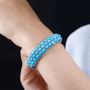 turquoise and neon blue apatite cluster bangle bracelet in rhodium over sterling silver worn on a wrist
