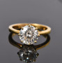 round moissanite solitaire ring in 18k yellow gold over sterling silver shown in a lifestyle photo