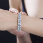 larimar moonstone blue topaz and zircon cluster tennis bracelet in rhodium over sterling silver worn on a wrist
