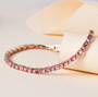 pink tourmaline and moissanite tennis bracelet in 18k rose gold over sterling silver shown in a lifestyle photo
