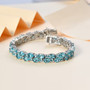 blue apatite double row tennis bracelet in rhodium over sterling silver shown in a lifestyle photo
