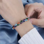 multi gemstone double row tennis bracelet in rhodium over sterling silver worn on a wrist