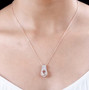 morganite and moissanite pendant necklace in 18k rose gold over sterling silver worn around the neck