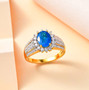 neon blue apatite and moissanite ring in 18k yellow gold over sterling silver shown in a lifestyle photo