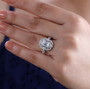 moissanite halo cluster ring in rhodium over sterling silver worn on a hand
