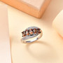 andalusite and white zircon cluster bypass ring in rhodium over sterling silver shown in a lifestyle photo