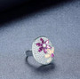 close up of ethiopian opal rhodolite garnet and white zircon cluster ring in rhodium over sterling silver