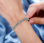 green apatite and white zircon tennis bracelet in rhodium over sterling silver worn on a wrist