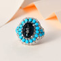 london blue topaz turquoise and moissanite ring in rhodium over sterling silver shown in a lifestyle photo