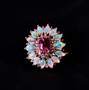 close up of pink tourmaline opal and pink sapphire halo cluster ring in 18k rose gold over sterling silver
