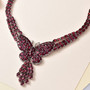 rhodolite garnet butterfly cluster necklace in rhodium over sterling silver shown in a lifestyle photo