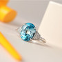 cambodian blue zircon and diamond ring in solid 14k white gold shown in a lifestyle photo
