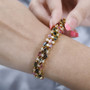 multi color tourmaline and white zircon triple row tennis bracelet in rhodium over sterling silver worn on a wrist