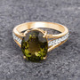 green tourmaline and diamond ring in solid 14k yellow gold shown in a lifestyle photo