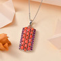 peach opal and rhodolite garnet pendant necklace in rhodium over sterling silver shown in a lifestyle photo