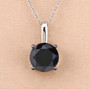 round black diamond solitaire pendant necklace in solid 14k white gold shown in a lifestyle photo