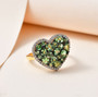 tsavorite garnet and moissanite heart shaped cluster ring in 18k yellow gold over sterling silver shown in a lifestyle photo