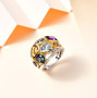 multi gemstone bezel set two-tone wide band ring in 18k yellow gold and rhodium over sterling silver shown in a lifestyle photo