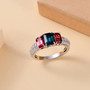 indicolite tourmaline rubellite tourmaline and moissanite trilogy ring in rhodium over sterling silver shown in a lifestyle photo
