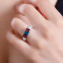 indicolite tourmaline rubellite tourmaline and moissanite trilogy ring in rhodium over sterling silver worn on a hand