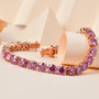 round pink moissanite tennis bracelet in 18k rose gold over sterling silver shown in a lifestyle photo