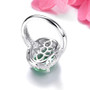 back view of oval green fluorite and white zircon halo ring in rhodium over sterling silver
