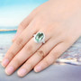 oval green fluorite and white zircon halo ring in rhodium over sterling silver worn on a hand