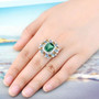 green fluorite citrine blue topaz and zircon halo cocktail ring in rhodium over sterling silver worn on a hand