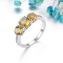 citrine three stone and white zircon accent ring in rhodium over sterling silver shown in a lifestyle photo