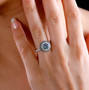 aquamarine champagne and white diamond round double halo solid 14k yellow gold ring worn on a hand