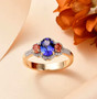 tanzanite padparadscha sapphire and diamond ring in solid 14k yellow gold shown in a lifestyle photo