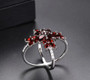 close up of garnet and white zircon ring in rhodium over sterling silver
