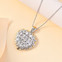 white topaz heart shaped cluster pendant necklace in two-tone 18k yellow gold and rhodium over sterling silver shown in a lifestyle photo