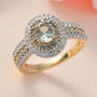 alexandrite and moissanite halo ring in 10k yellow gold shown in a lifestyle photo