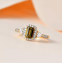 golden tanzanite and moissanite emerald cut halo ring in 18k yellow gold over sterling silver shown in a lifestyle photo