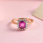 pink sapphire and moissanite halo ring in 10k rose gold shown in a lifestyle photo