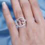 morganite pink cushion and white diamond halo ring in 14k rose gold worn on a hand