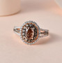 oval champagne and white diamond halo ring in 14k rose gold shown in a lifestyle photo