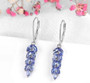 close up of tanzanite dangle earrings in rhodium over sterling silver