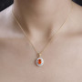 oval fire opal and moissanite halo pendant necklace in rhodium and 18k yellow gold over sterling silver worn around the neck